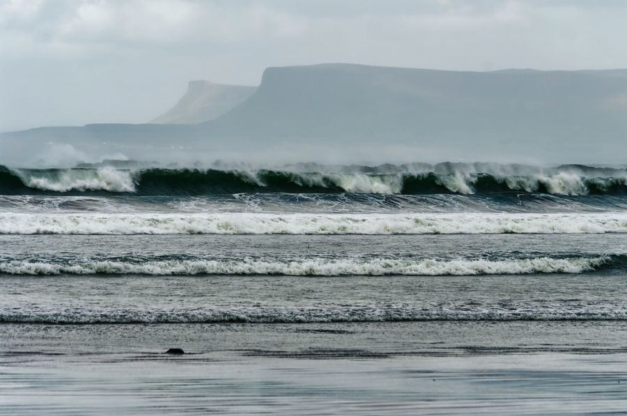 Ocean waves crashing on shore in County Sligo, Ireland — the unpredictable force that well-designed systems are built to withstand.
